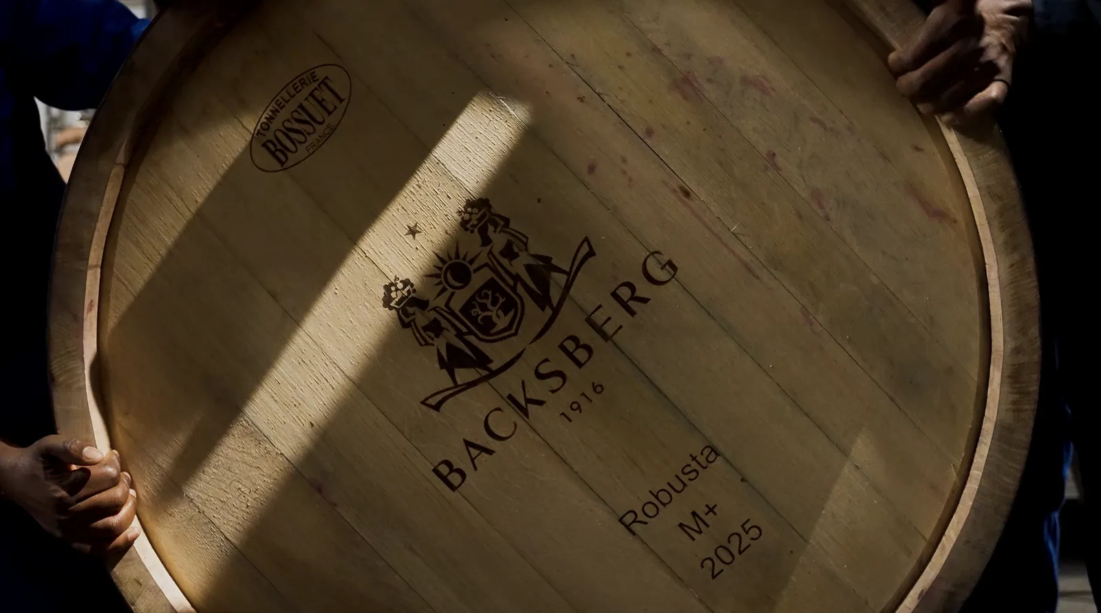 A Backsberg barrel head held up to the light