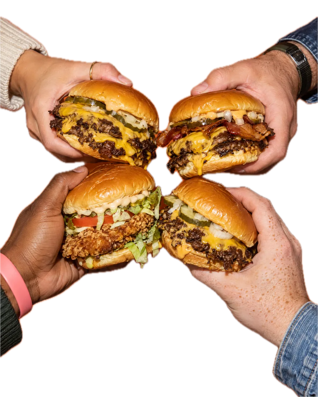 Four hands bring four burgers together while a word wall slides behind them