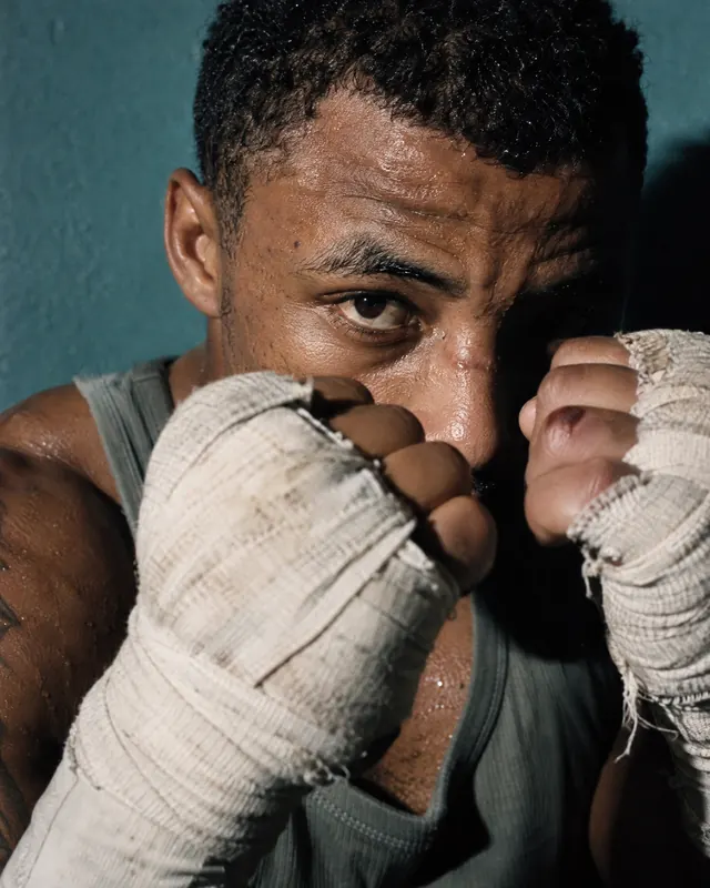A boxer's wrapped fists raised in guard